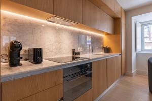 a kitchen with a counter with a coffee maker on it at Palácio Ficalho Townouse 1 by LovelyStay in Lisbon
