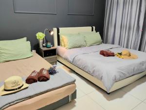 two beds with hats and football equipment on them at Arte Mont Kiara KLCC Changkat Bukit Bintang Publika 4 Pax Jalan Alor Pavilion 1R2B in Kuala Lumpur