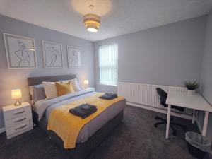 a bedroom with a bed and a desk and a desk at Large 3 bed House Wolverhampton Families and Contractors in Wolverhampton +30 photos
