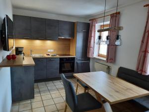 a kitchen with a wooden table and a dining room at Beim Draxl in Reit im Winkl