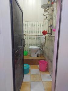 a bathroom with a toilet and buckets in it at Annu Bhai sewa sadan in Mathura