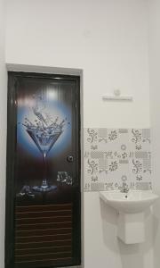 a bathroom with a drink dispenser next to a sink at Silver home stay vagamon in Vagamon