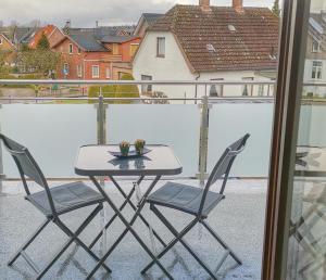 a table and two chairs on a balcony at Apartmentvermittlung Mehr als Meer - Objekt 46 in Niendorf