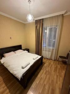 a bedroom with a large bed and a window at Comfortable House the city centr in Kutaisi