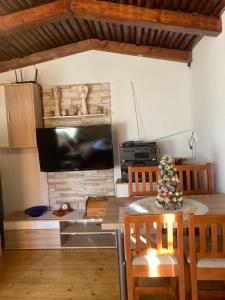 a dining room with a table with a christmas tree on it at Chalúpka Mischel in Raková