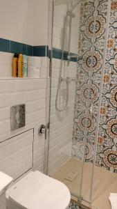 a bathroom with a shower and a toilet at Tre Gigli Firenze BB, 5 minutes from station, via Palazzuolo 55 in Florence