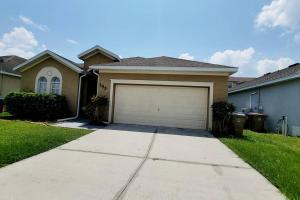 a house with a garage in the yard at Beautiful, home in a gated community in Kissimmee