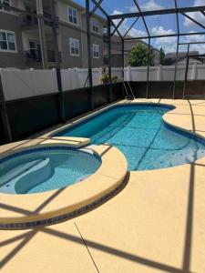 a large swimming pool in front of a building at Beautiful, home in a gated community in Kissimmee