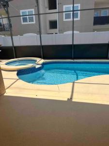 a swimming pool with two toilets in a building at Beautiful, home in a gated community in Kissimmee