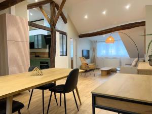 ein Wohnzimmer mit einem Holztisch und Stühlen in der Unterkunft Beautilful flat in Saint germain en laye in Saint-Germain-en-Laye