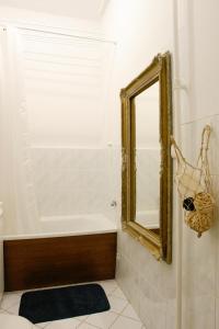a bathroom with a bath tub and a mirror at Home in the Old Town in Warsaw