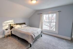 a white bedroom with a bed and a window at Spacious Rockford Retreat Walk Downtown! in Rockford