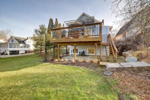 a large house with a large deck on a yard at Spacious Rockford Retreat Walk Downtown! in Rockford