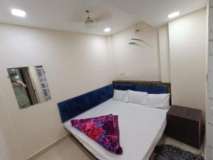 a small bedroom with a bed in a room at BLUE TOWER in Ujjain