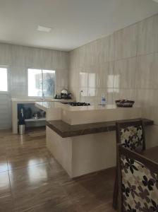 a kitchen with a sink and a counter top at Casa Mar Azul in Pitimbu