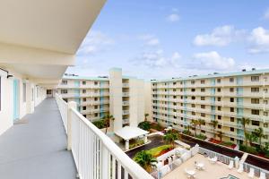 an apartment balcony with a view of a building at Corner on Cocoa in Cocoa Beach