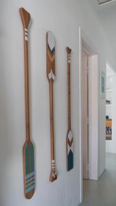 four wooden axes hanging on a wall at Cabana da Comporta in Comporta