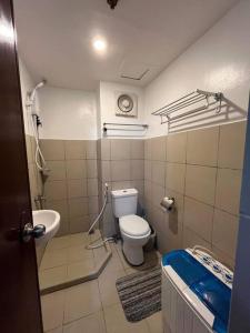 a small bathroom with a toilet and a sink at Cozy & near Airport, Mall & Samal Island in Davao City
