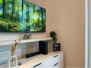 a television on a wall above a desk at Penthouse Flat in Manchester in Manchester