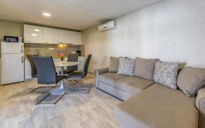 a living room with a couch and a table at Mobile Homes Rocco 2 in Banjole