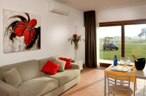 a living room with a couch and a table at Jesolo Living at Golf Club Jesolo in Jesolo