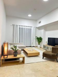 a living room with a couch and a tv at Lewish and stylish 1bhk at DSO in Dubai