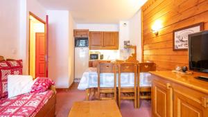 een woonkamer met een tafel en een keuken bij La Turra 407 - Appt familial 6 pers in Modane