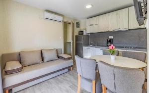a living room with a couch and a table at Mobile Homes Rocco 2 in Banjole