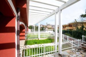 a white pergola on a building with a white fence at Monolocale con terrazzo a Sirolo - S052 in Sirolo