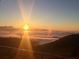 einen Blick auf die Sonne, die über einem Meer von Wolken aufgeht in der Unterkunft Dorf 70 in Eichenberg