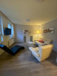 a living room with a couch and a chair at Apartments in der Rostocker Innenstadt in Rostock