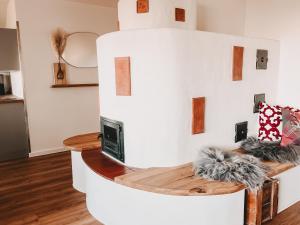 a living room with a table with a tv at Dorf 70 in Eichenberg