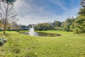 a pond with a fountain in the middle of a park at Palm Coast Townhome with Pool Access about 4 Mi to Beach in Palm Coast