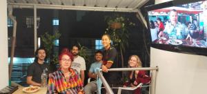 a group of people standing in front of a tv at Hostel Metro Floresta Alojamiento in Medellín