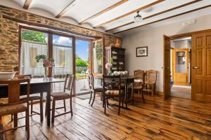 a dining room with a table and chairs at Casa Peleyón in Castropol