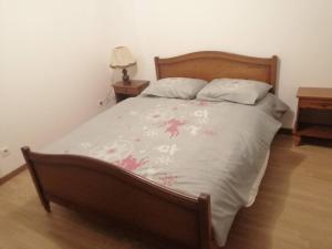 um quarto com uma cama e uma cabeceira em madeira em La Molette - 4 personnes em Saint-Julien-Molin-Molette
