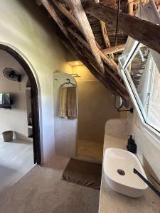 a bathroom with a sink and a window at Kuwa Zanzibar in Kiwengwa