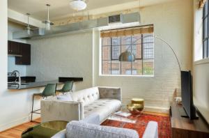 a living room with a white couch and a table at Constance Lofts by Black Swan in New Orleans