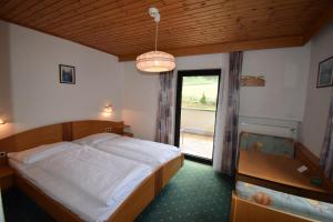 a bedroom with a bed and a large window at Hotel Montana in Solda