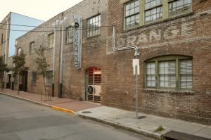 a brick building with a sign on the side of it at Constance Lofts by Black Swan in New Orleans