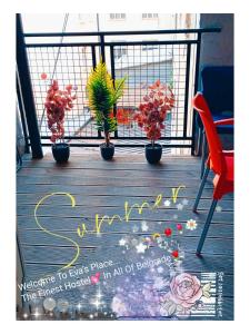 a welcome sign on a deck with plants and flowers at STUDIO Eva in Sajmište