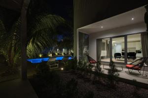 a house with a swimming pool at night at Résidence Gabriel in Sali Nianiaral