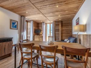 a dining room with a wooden table and chairs at Appartement La Clusaz, 4 pièces, 8 personnes - FR-1-437-71 in La Clusaz