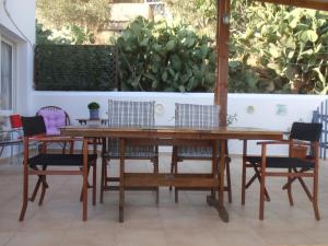 a wooden table and chairs in a patio at Traditional apartment in Kalymnos