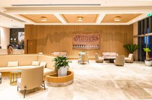 a lobby with couches and chairs and a bar at Hilton Garden Inn Samarkand Sogd in Samarkand