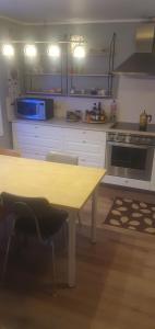 a kitchen with a table with chairs and a stove at Hóll in Óbyggðasetur