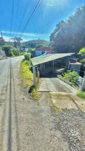 una calle vacía con un edificio al lado de una carretera en Monteverde River House, en Monteverde