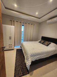 a bedroom with a bed and a cabinet in it at Puerta del Lago in San Bernardino