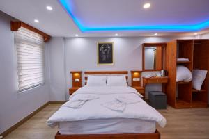 a bedroom with a large bed with a blue ceiling at Sabina Hotel near Grand Bazaar, city center in Istanbul