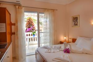 a bedroom with a bed and a large window at Haus Despina in Sarti
